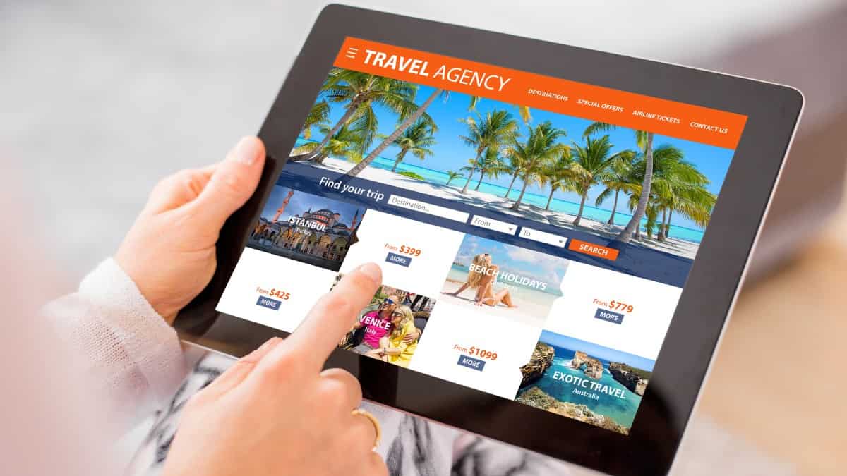 Travel agent with computer tablet and online travel deals.