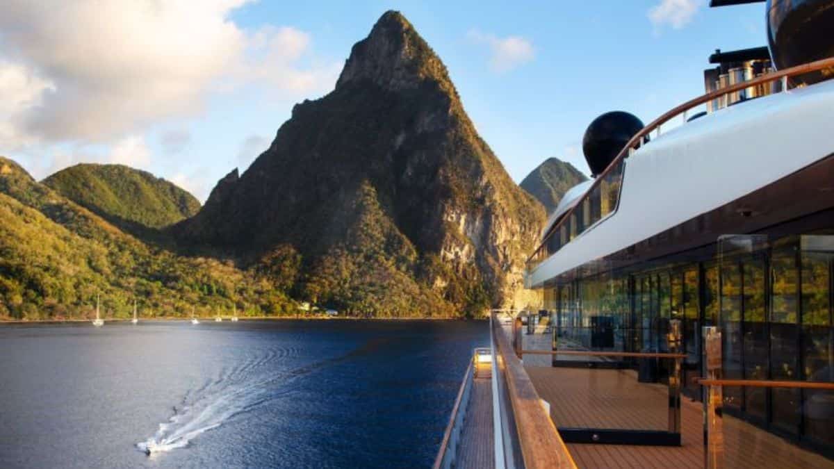 A superyacht deck view of the deep blue waters off the St. Lucia coast with the lush green covered Gros Piton in the background.