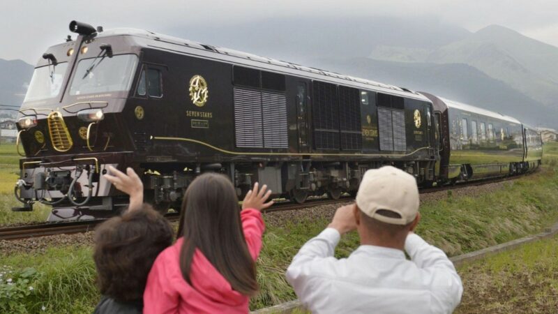 A family taking a photo of the worlds only 7 star luxury train